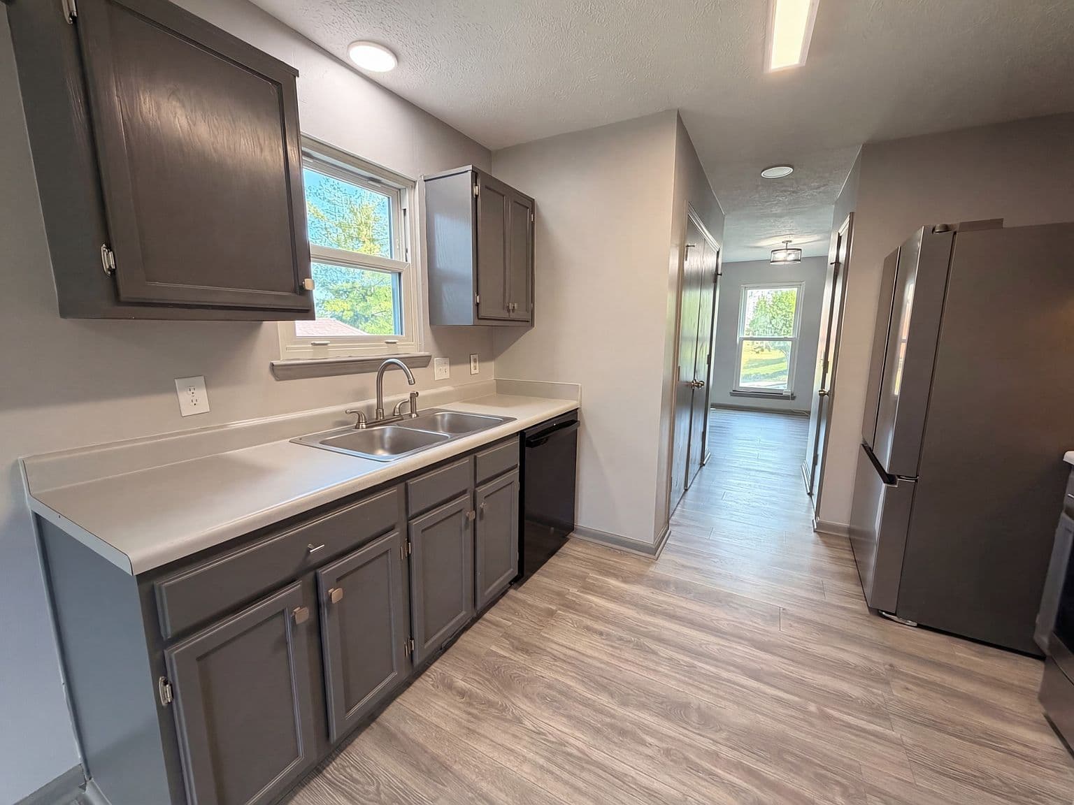 Galley kitchen with double sink and generous prep space.