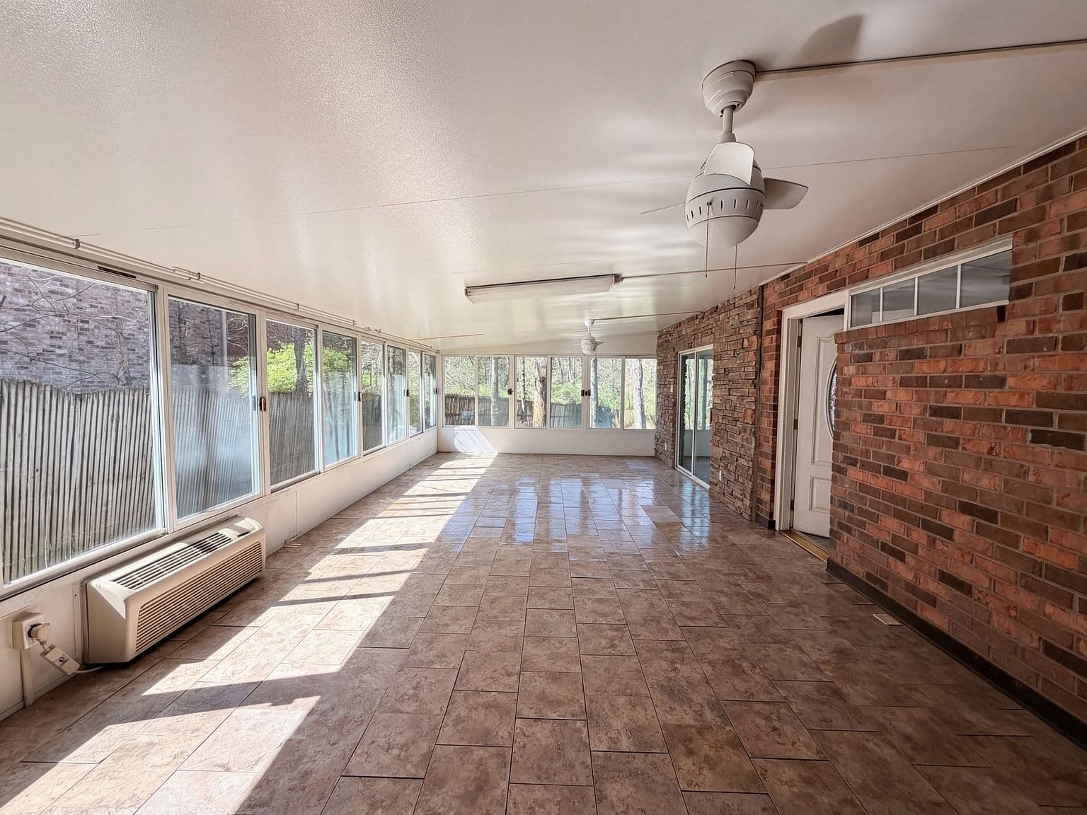 Sprawling 450-square-foot Florida room, wall-to-wall windows.