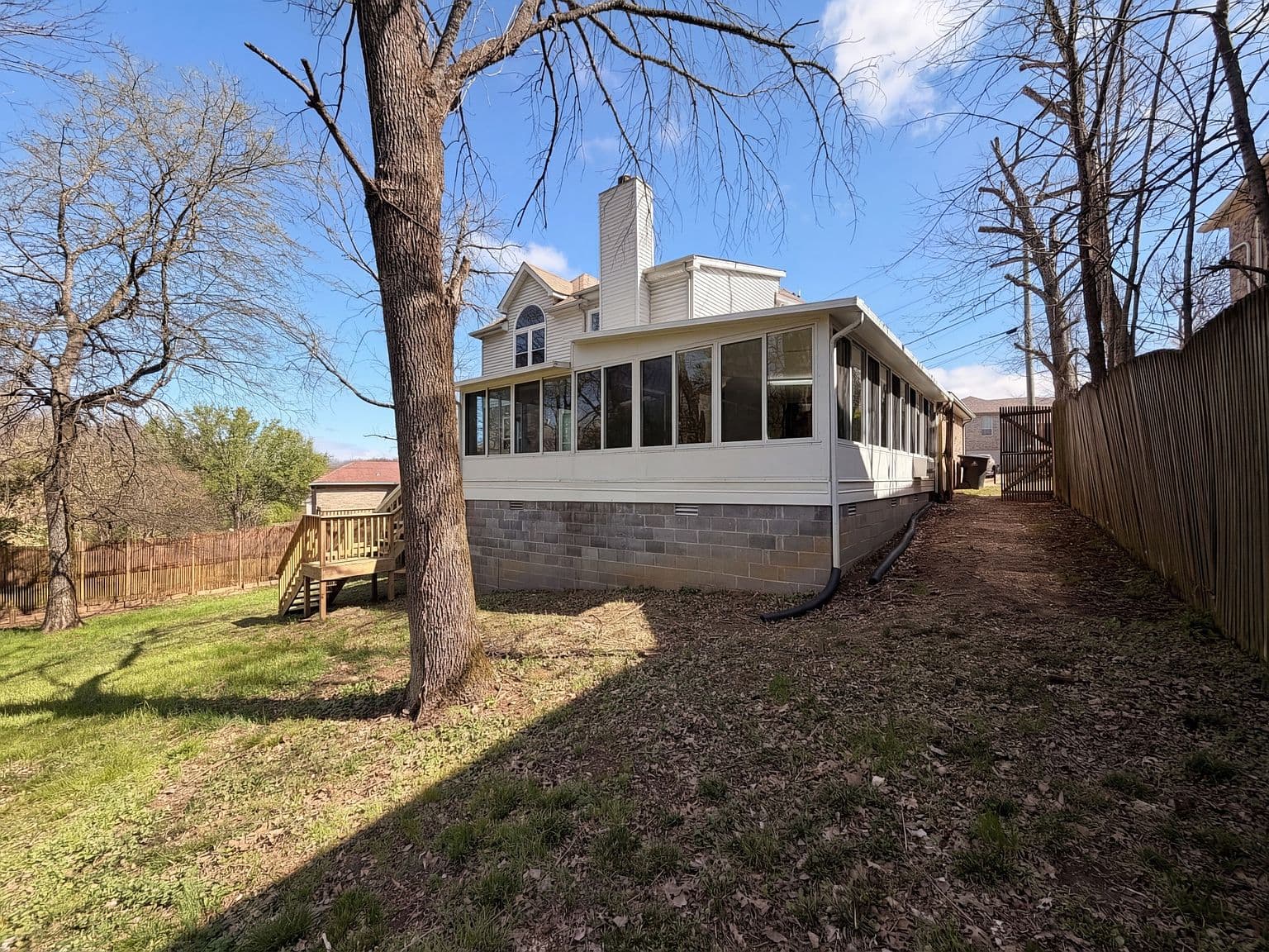Expansive yard views alongside the enclosed Florida room.