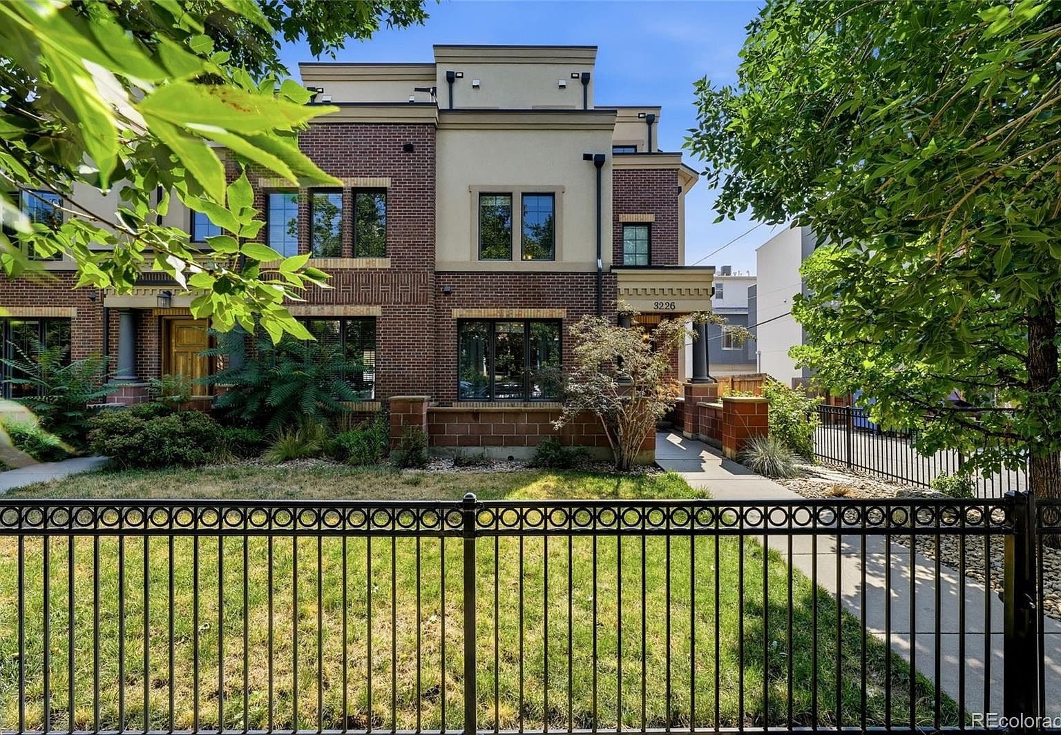 Contemporary end-unit row house with private front yard.
