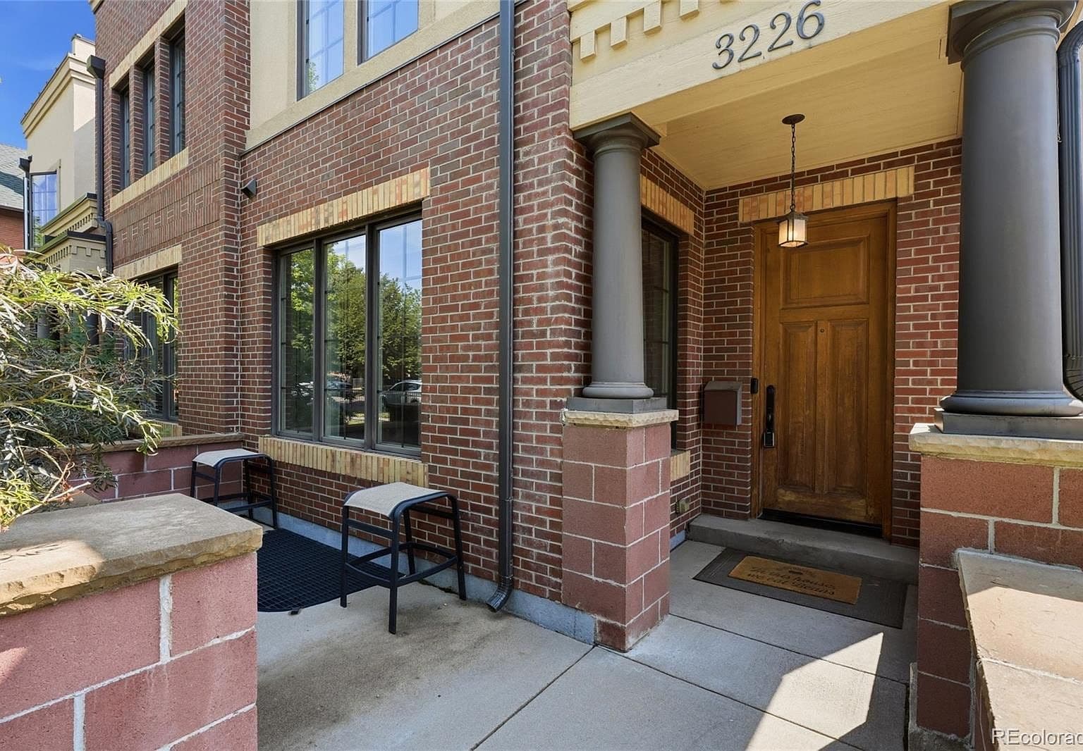 Welcoming covered entry with brick detailing and charm.
