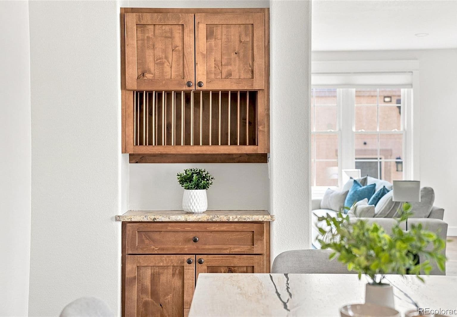 Built-in bar cabinetry with granite counter for entertaining.