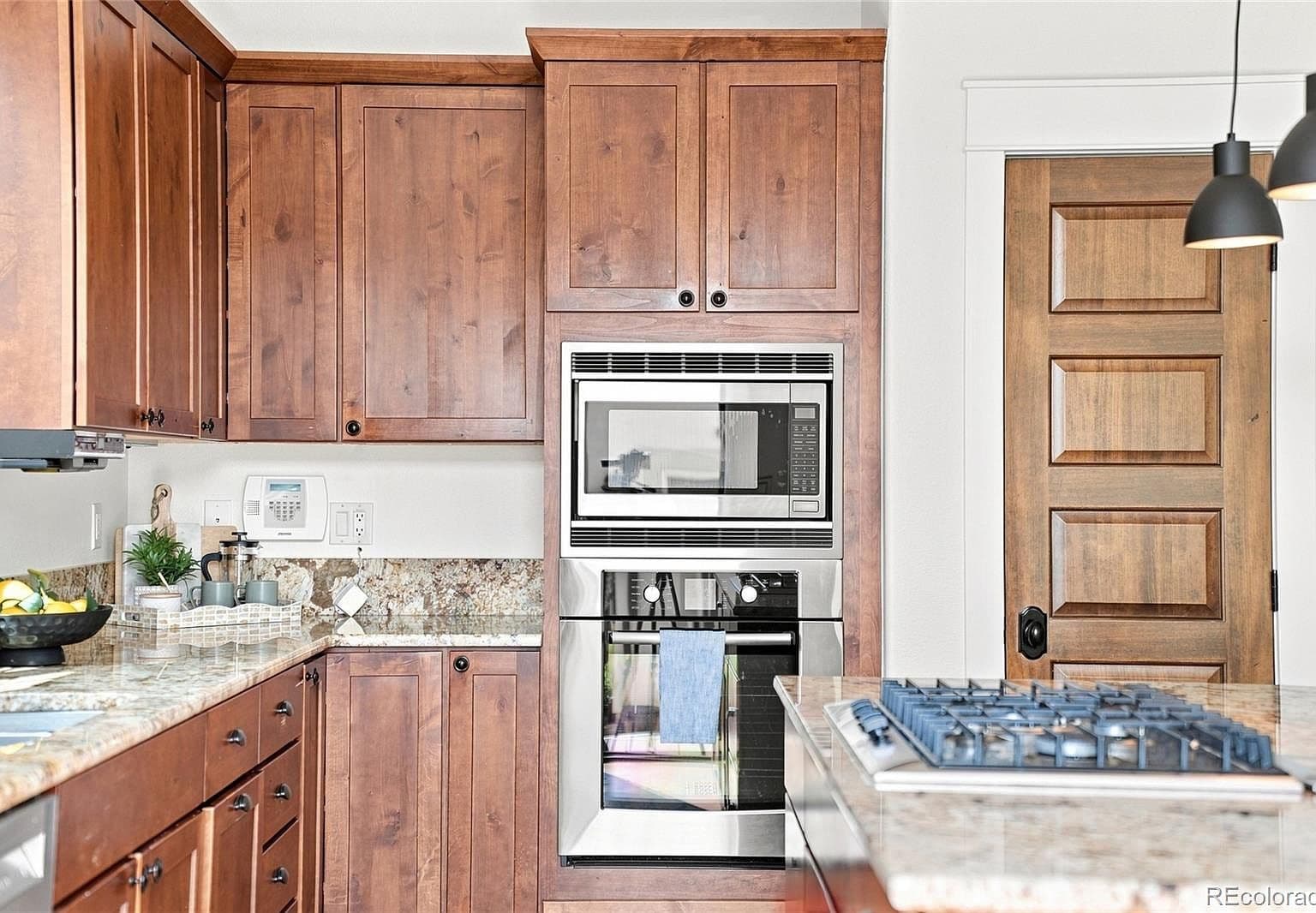 Bosch wall oven and microwave with rich cabinetry.