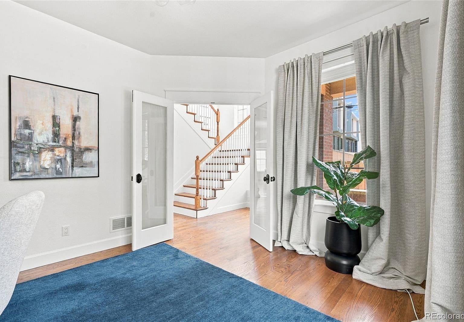 Private study with French doors and hardwood floors.