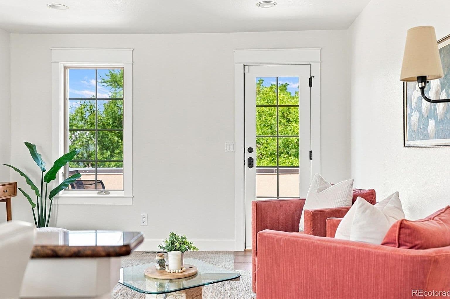 Top-level lounge opens to sunny patio doors.