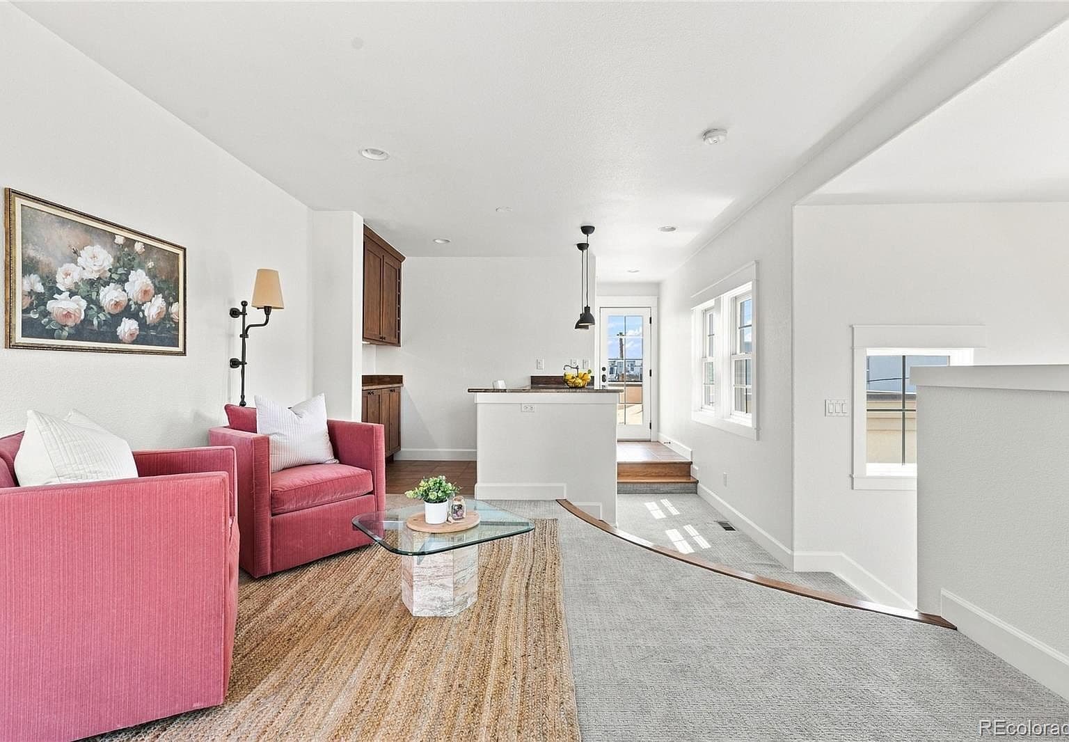 Bright lounge flows to designer kitchen and deck.