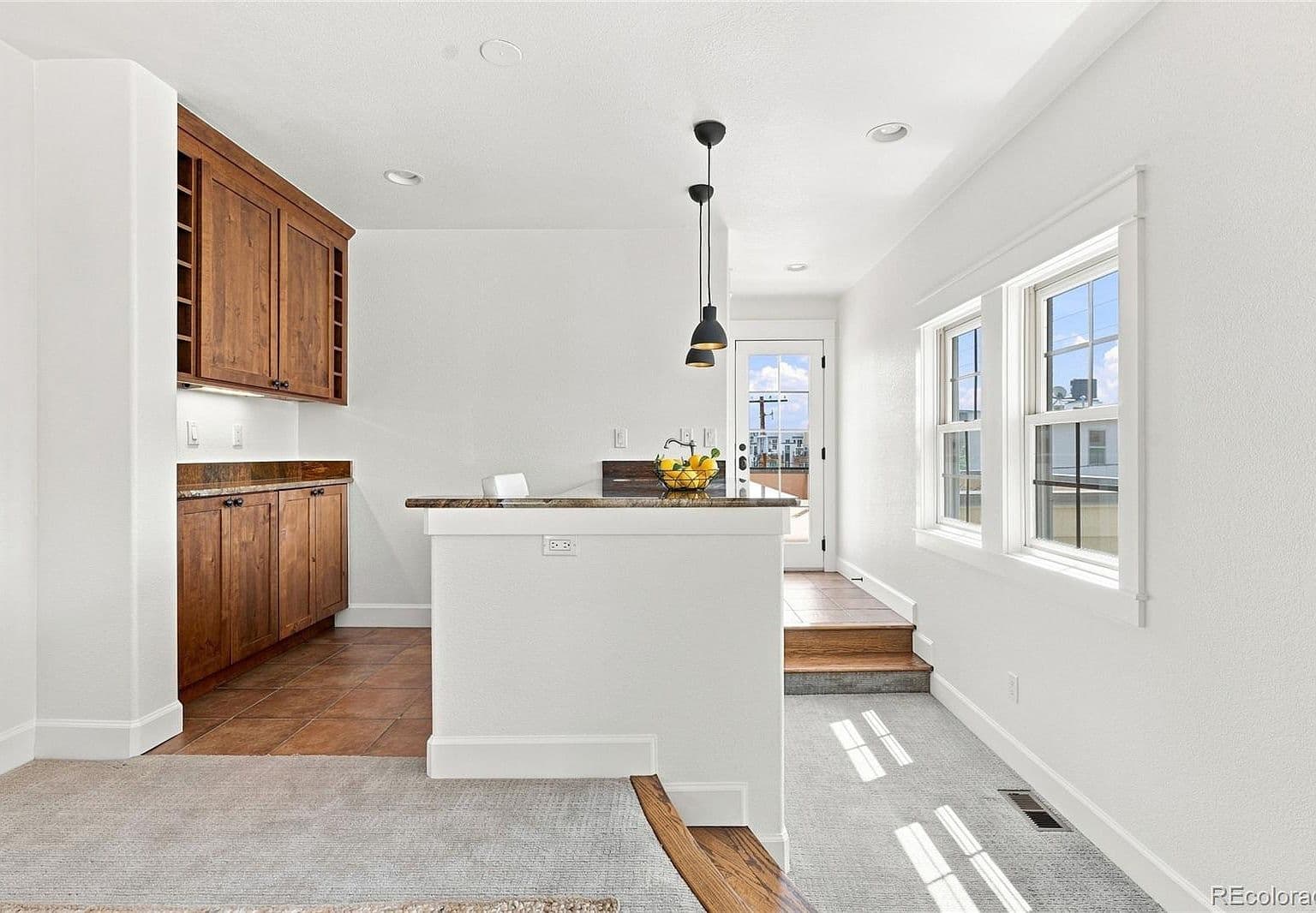 Granite-topped island and custom cabinetry for easy entertaining.