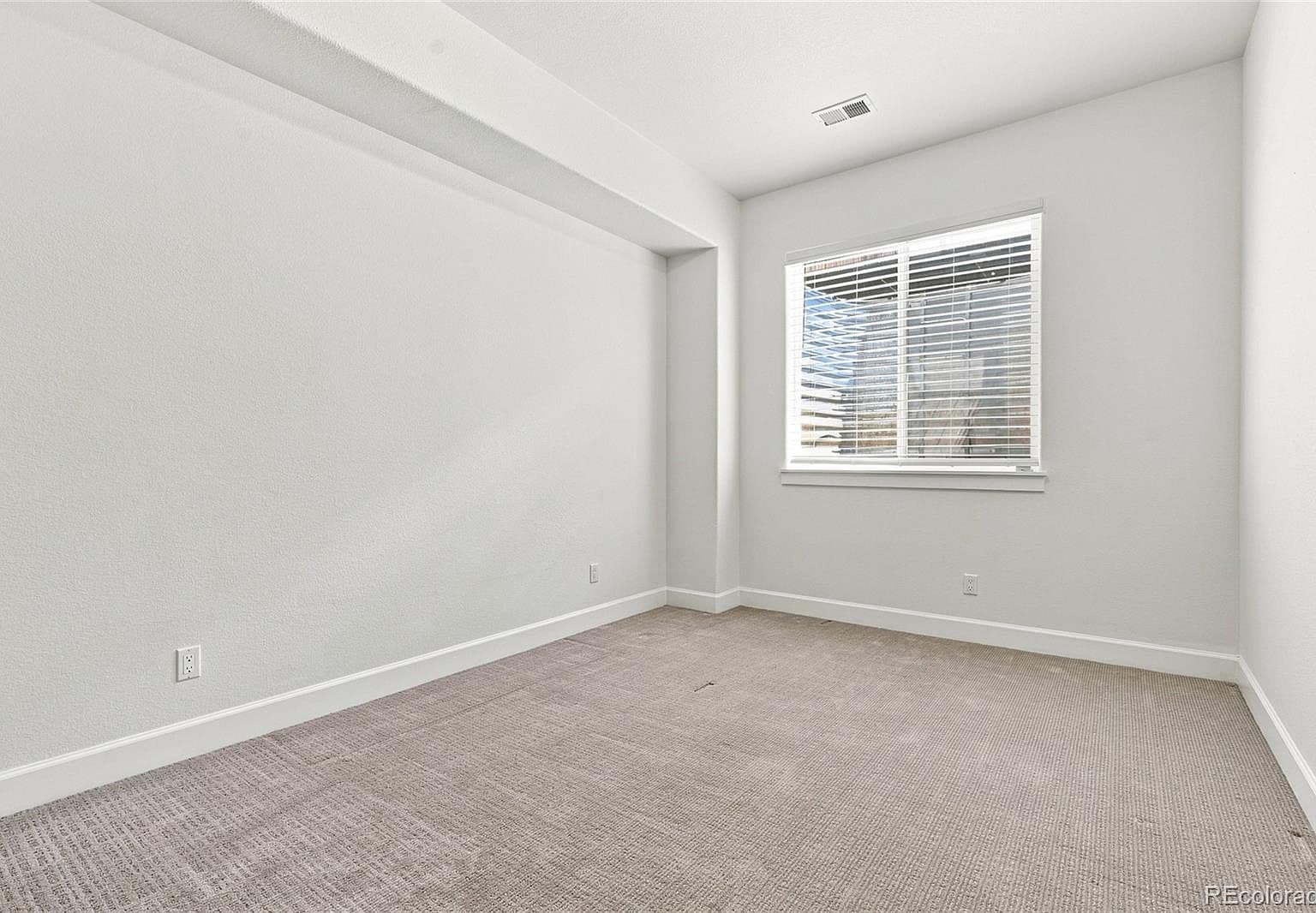 Quiet, flexible bedroom ideal for guests or home office.