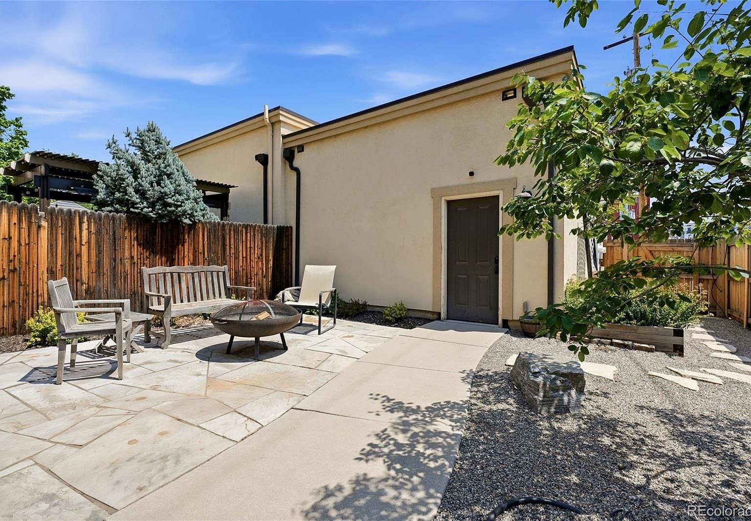 Secluded garden courtyard with seating and easy alley access.