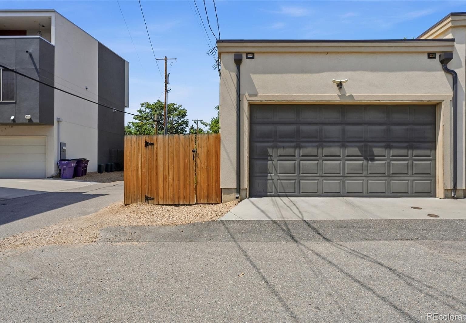 Oversized lighted two-car garage with secure gated entry.