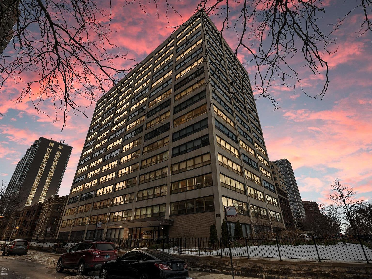 High-rise home on North Marine Drive beneath a sunset sky.
