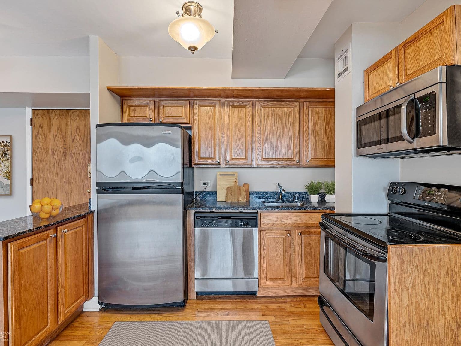 Wood cabinetry and stainless appliances complement this open kitchen.