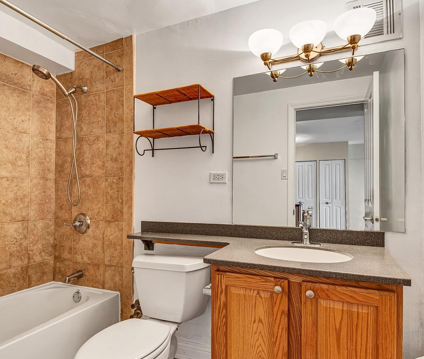 Full bathroom features a tiled shower and generous vanity.