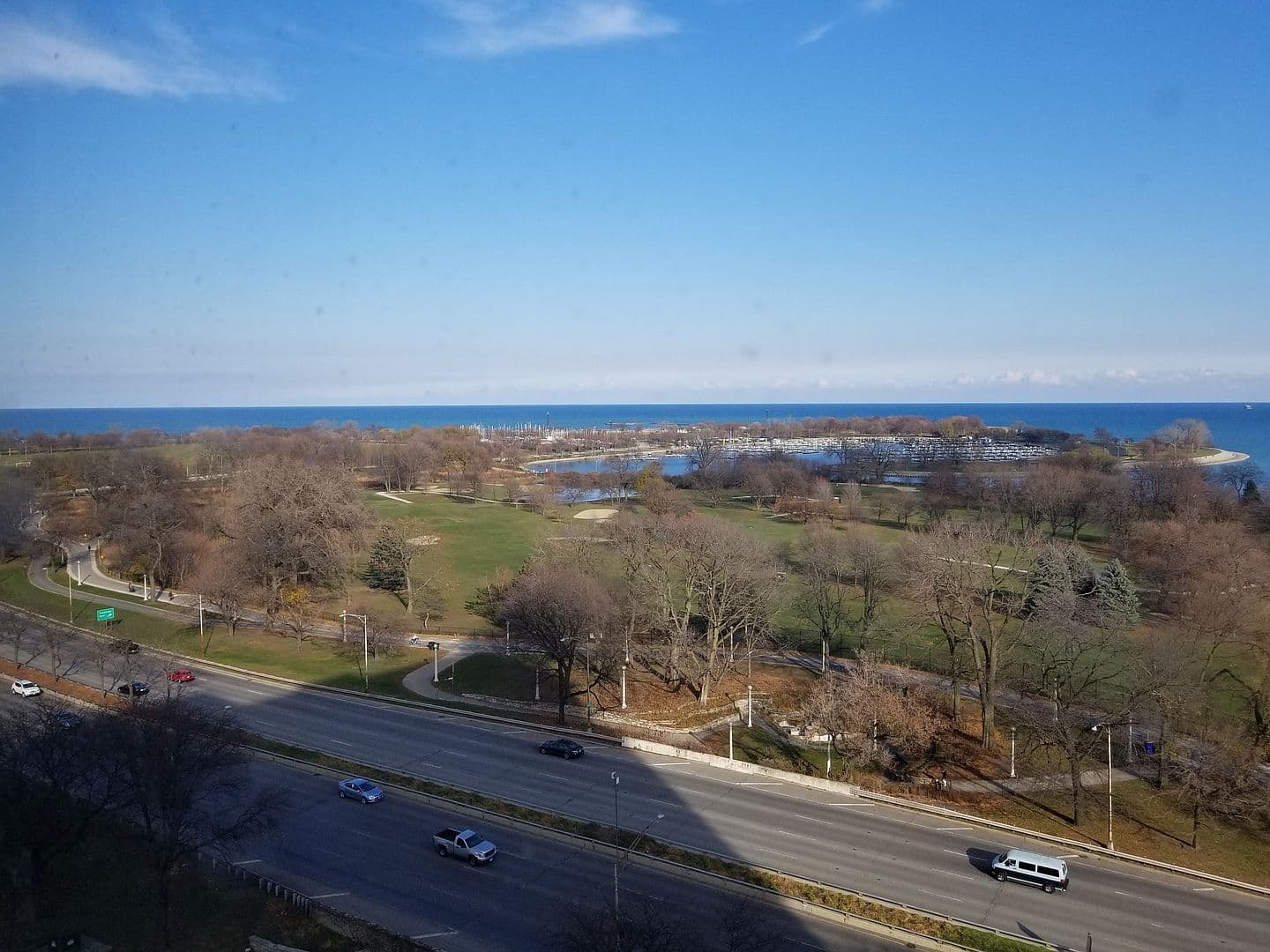 Elevated views overlook parkland, harbor, and Lake Michigan.