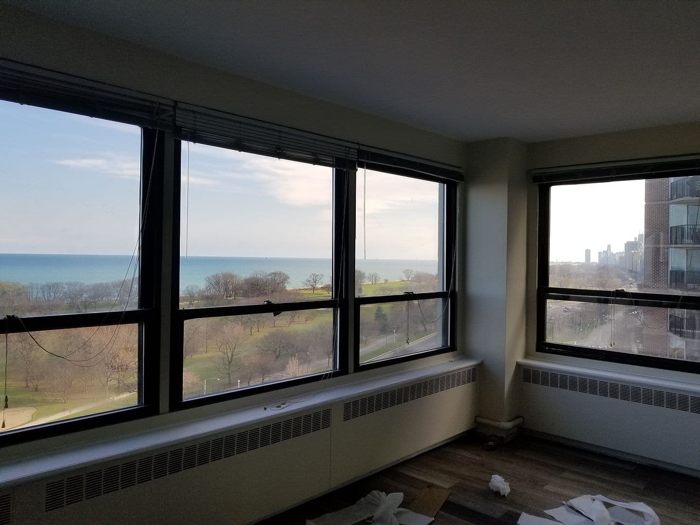 Corner windows frame sweeping lake and park views.