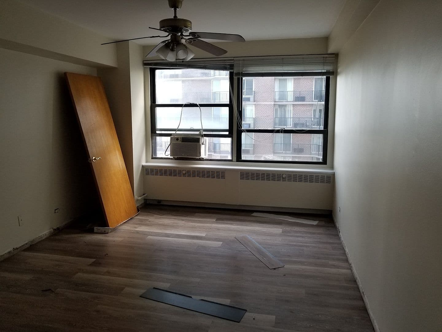 Bedroom offers generous floor space and wide windows.