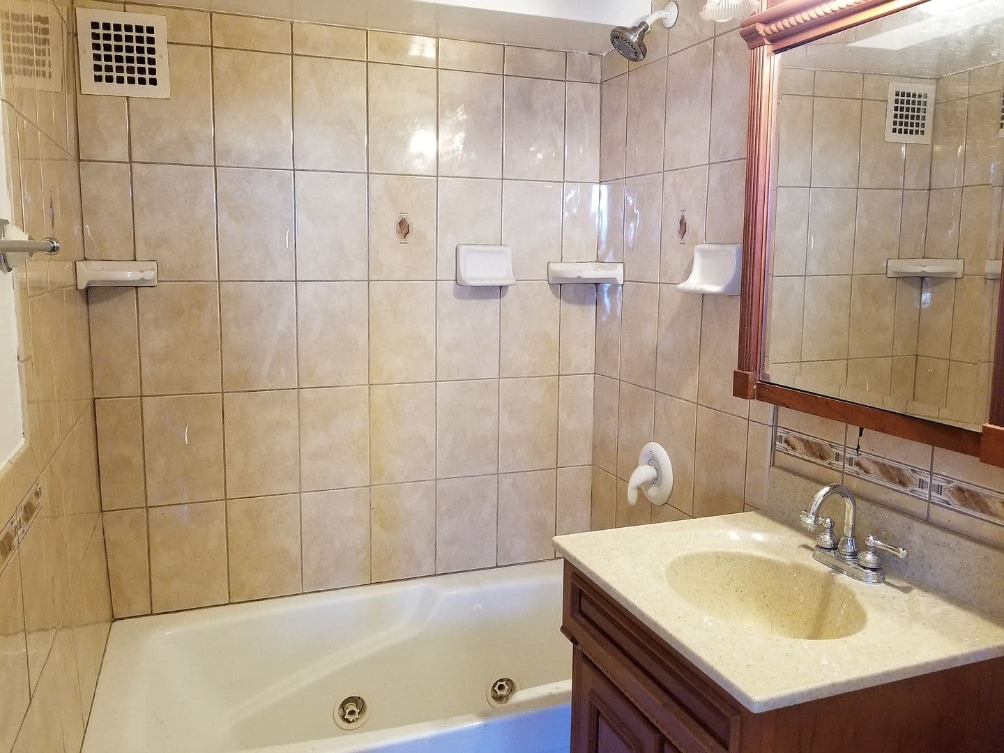 Second full bathroom pairs a soaking tub with tilework.