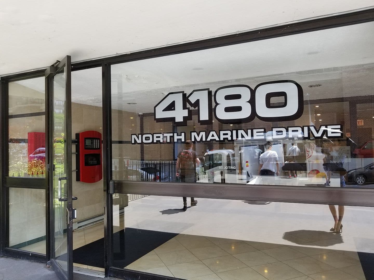Glass entry welcomes you to 4180 North Marine Drive.