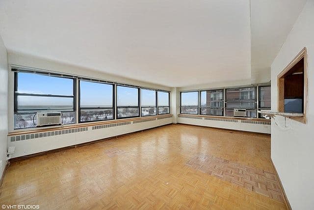 Corner windows fill the spacious living room with light