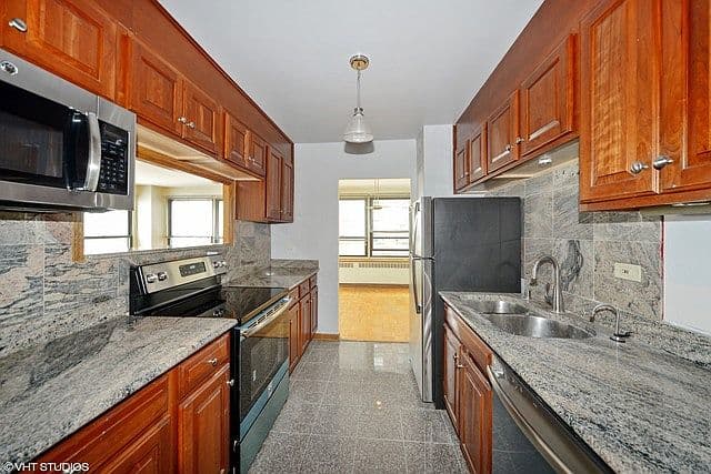 Galley kitchen features generous counter space and modern appliances