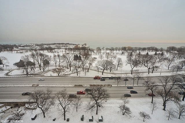 Snow-covered lakefront park stretches toward Lake Michigan