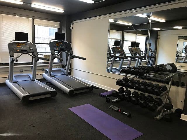 Fitness center with treadmills, dumbbells, and mirrored walls
