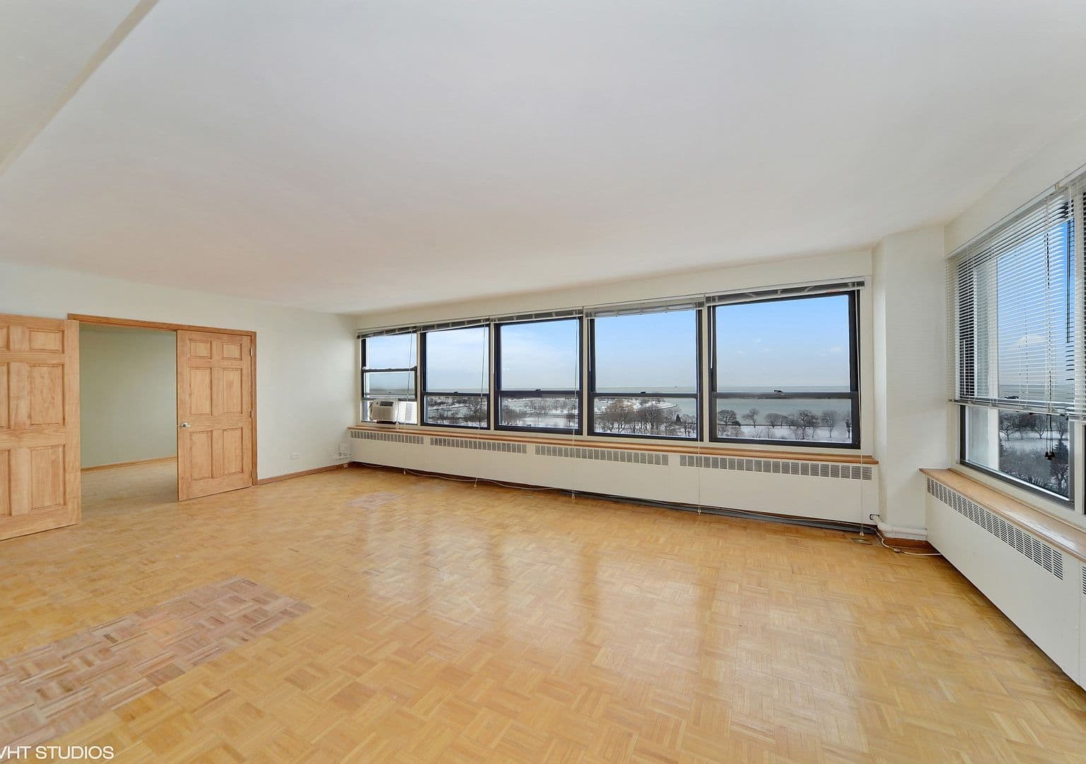 Spacious living room with parquet floors and lake views