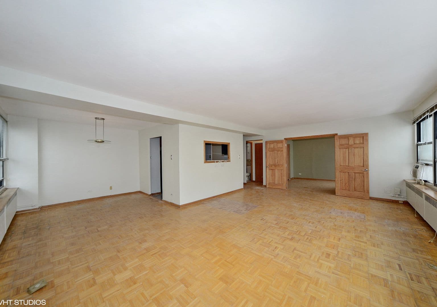 Open living area connects to the kitchen through a pass-through