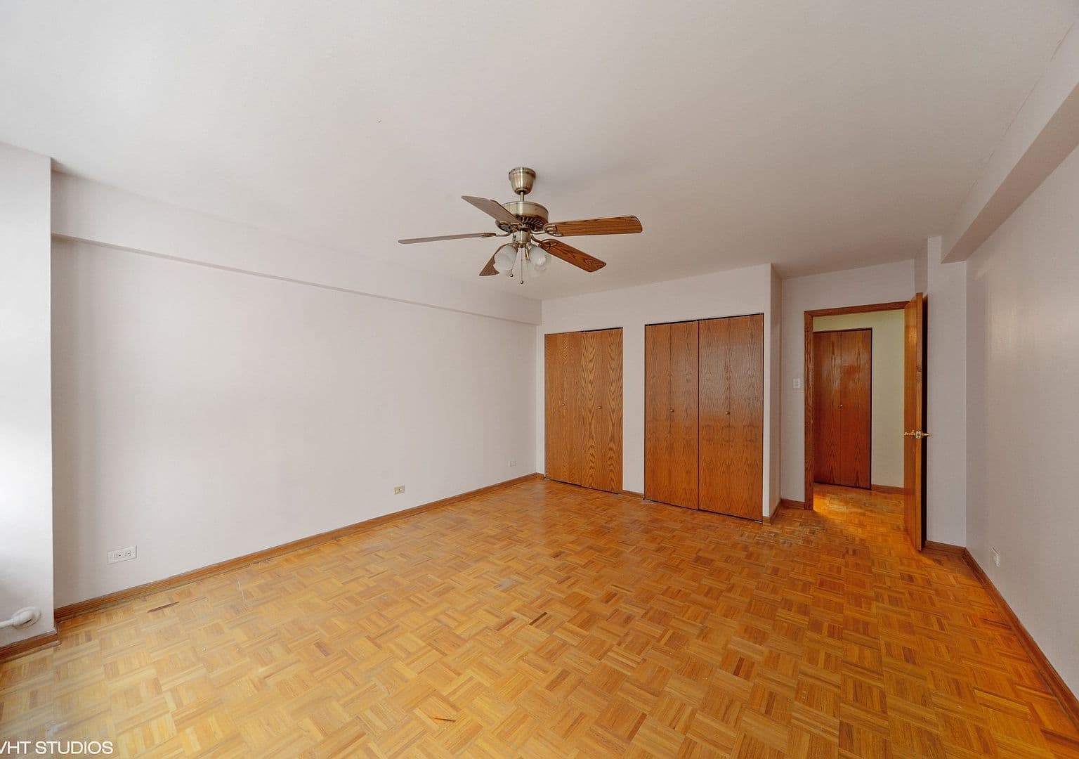 Generous bedroom offers two closets and a ceiling fan.