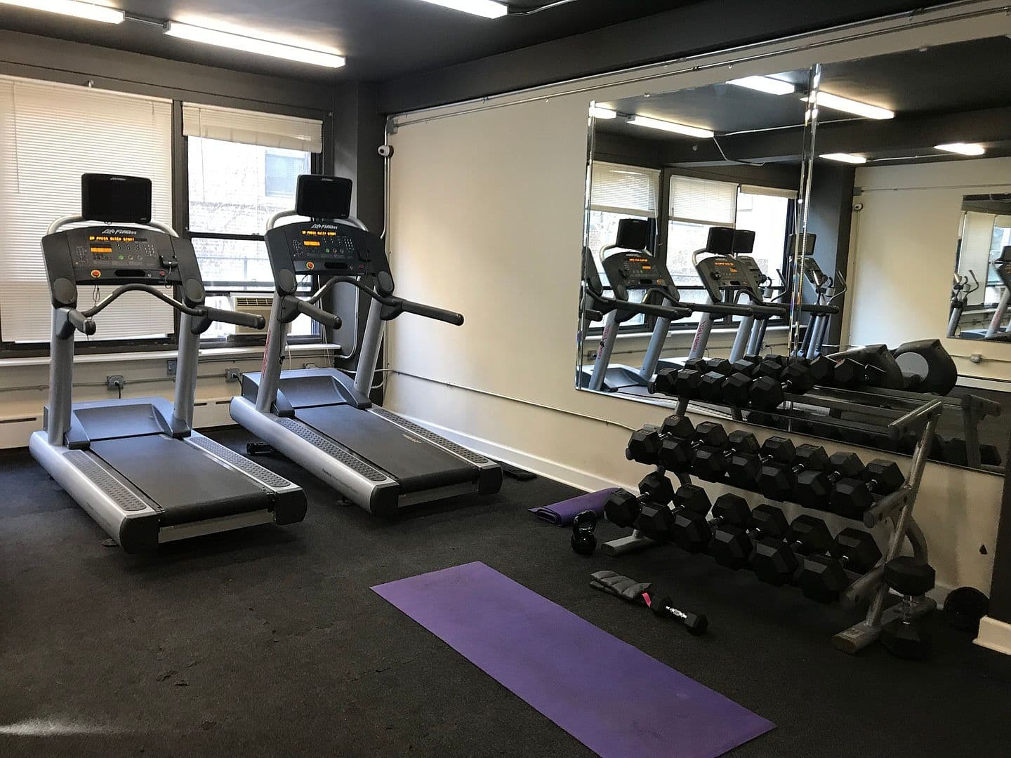 Building fitness center pairs treadmills with free weights.