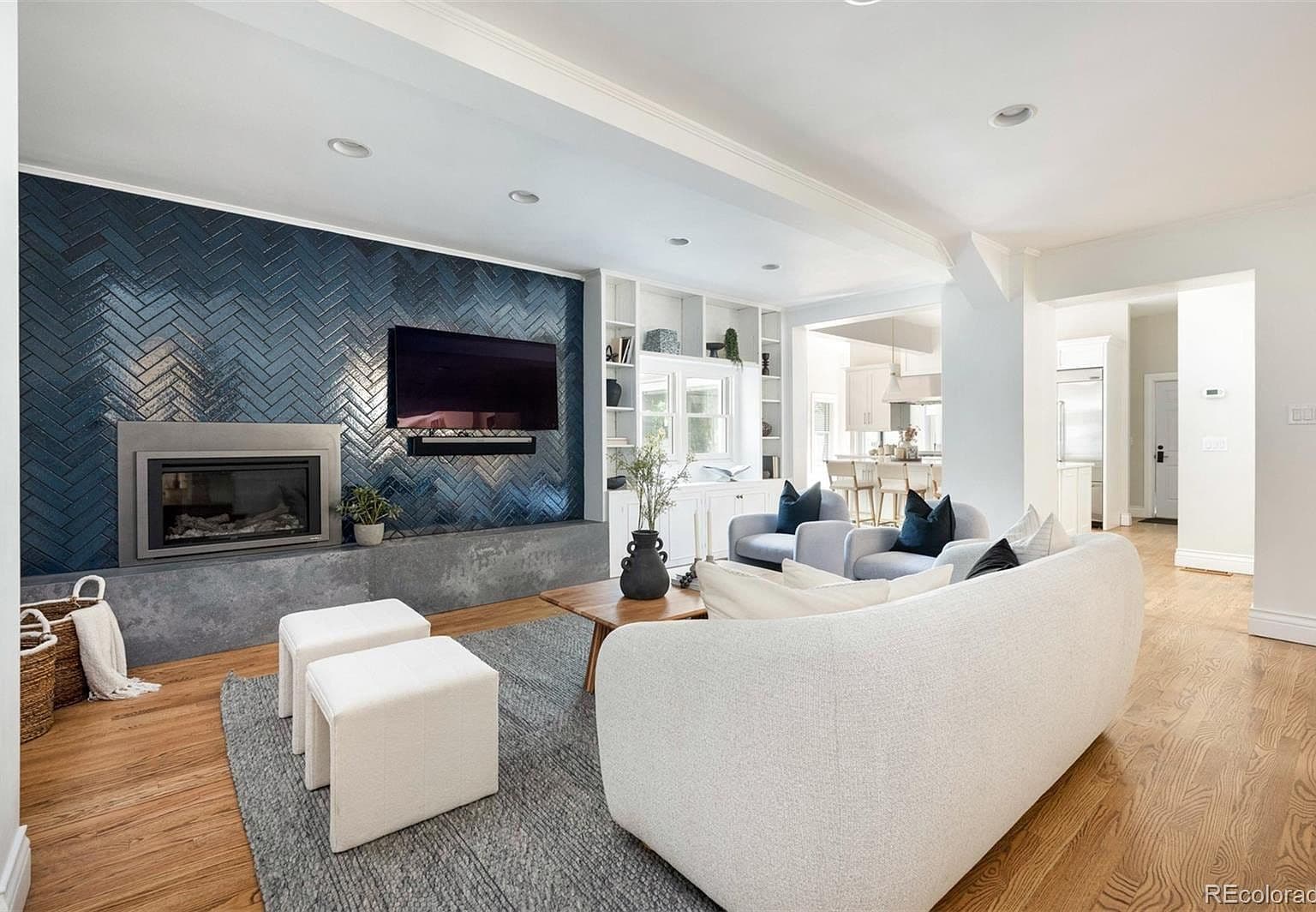Herringbone tile accent wall with built-in shelving