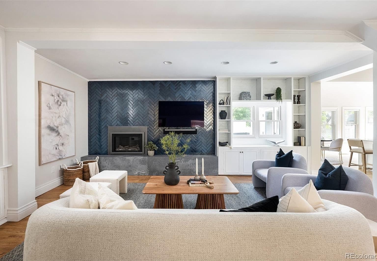 Gas fireplace set in glossy navy herringbone tile