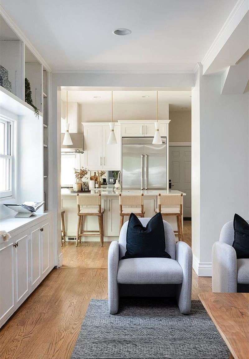 Sitting area overlooking island kitchen with pendant lighting