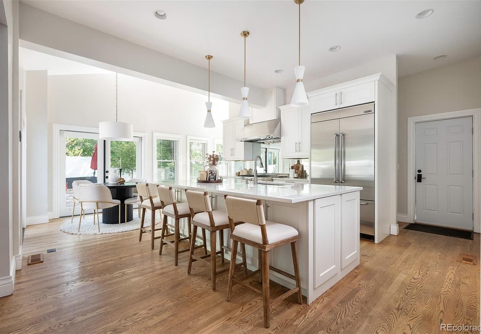 Quartz island kitchen opening to breakfast nook