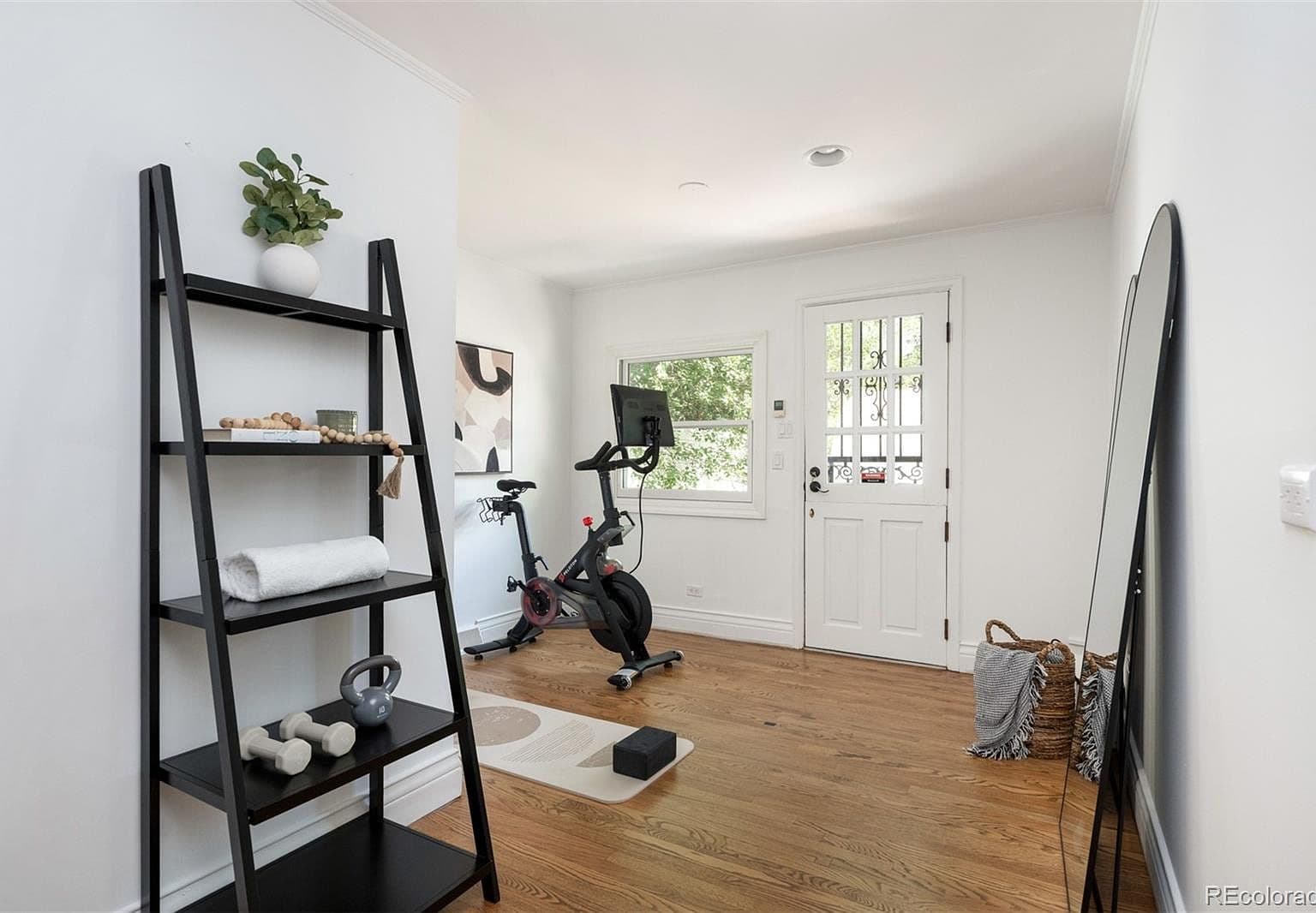 Bonus room outfitted as home gym with Dutch door