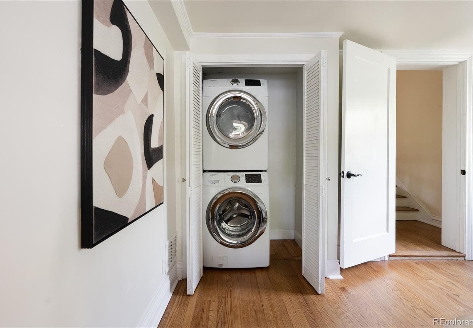 Stacked washer and dryer in hallway closet