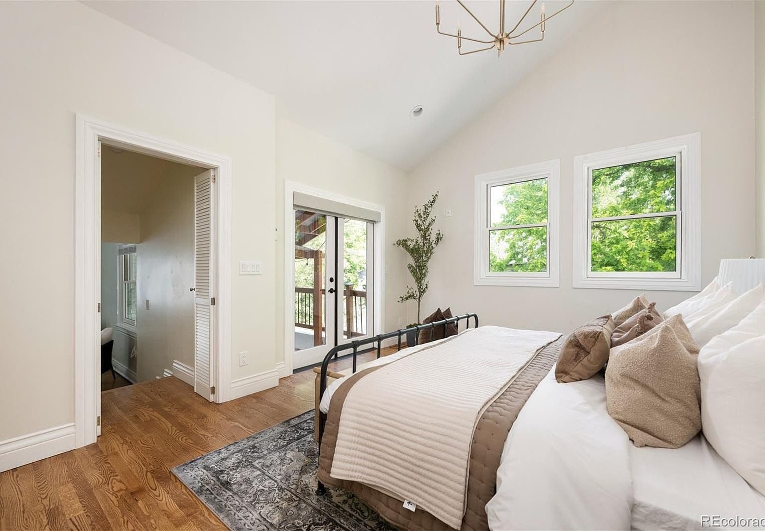 Primary bedroom with French doors to private balcony