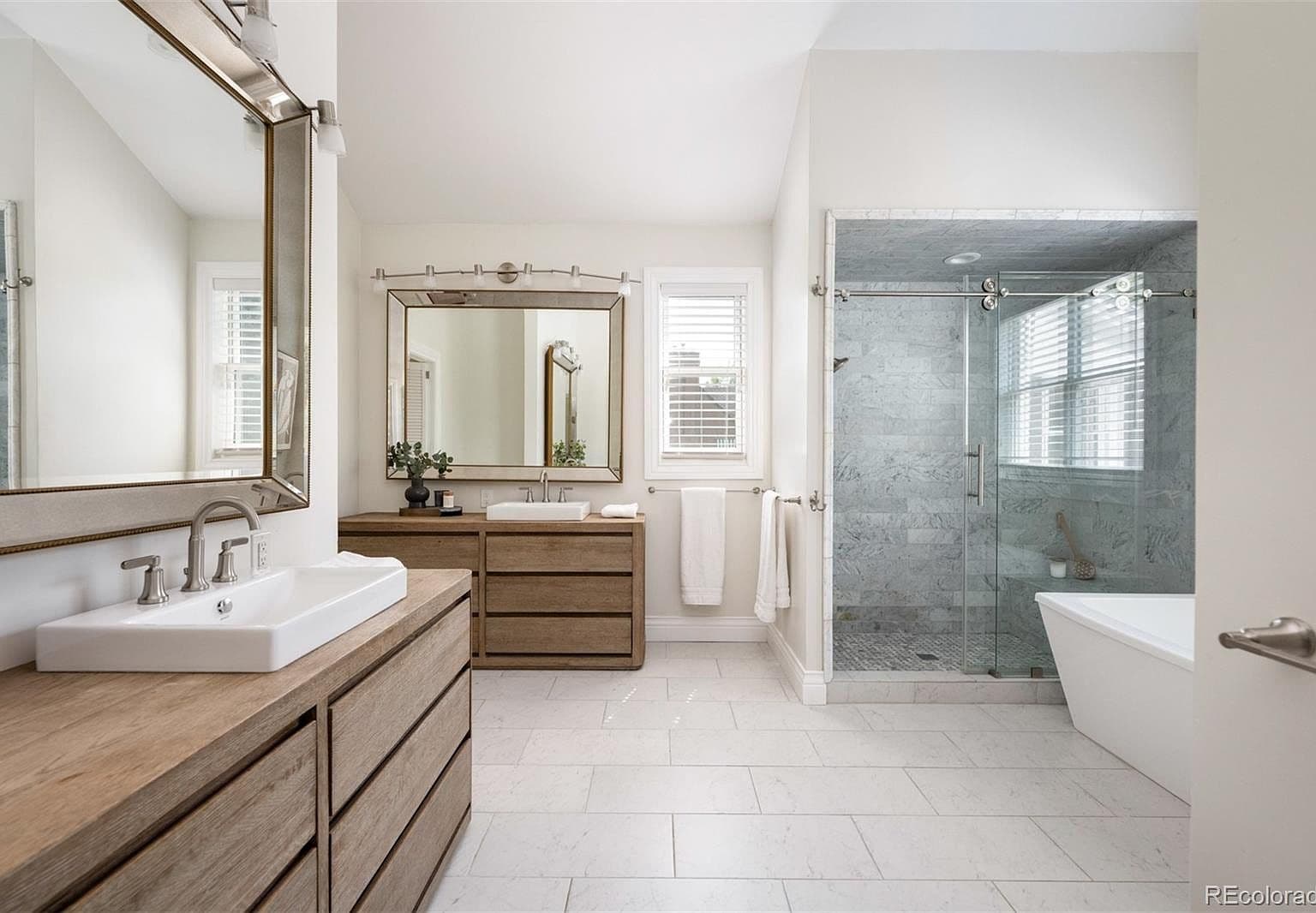Five-piece primary bath with marble shower and soaking tub
