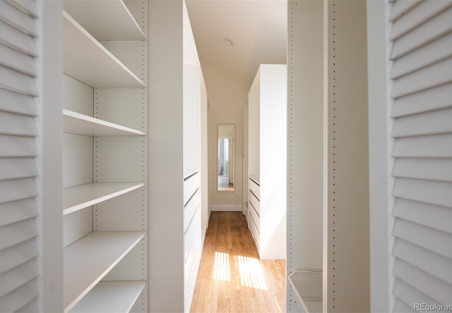 Walk-in closet with custom shelving and drawers