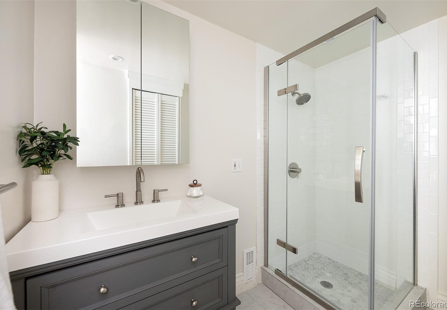 Guest bath with glass shower and gray vanity
