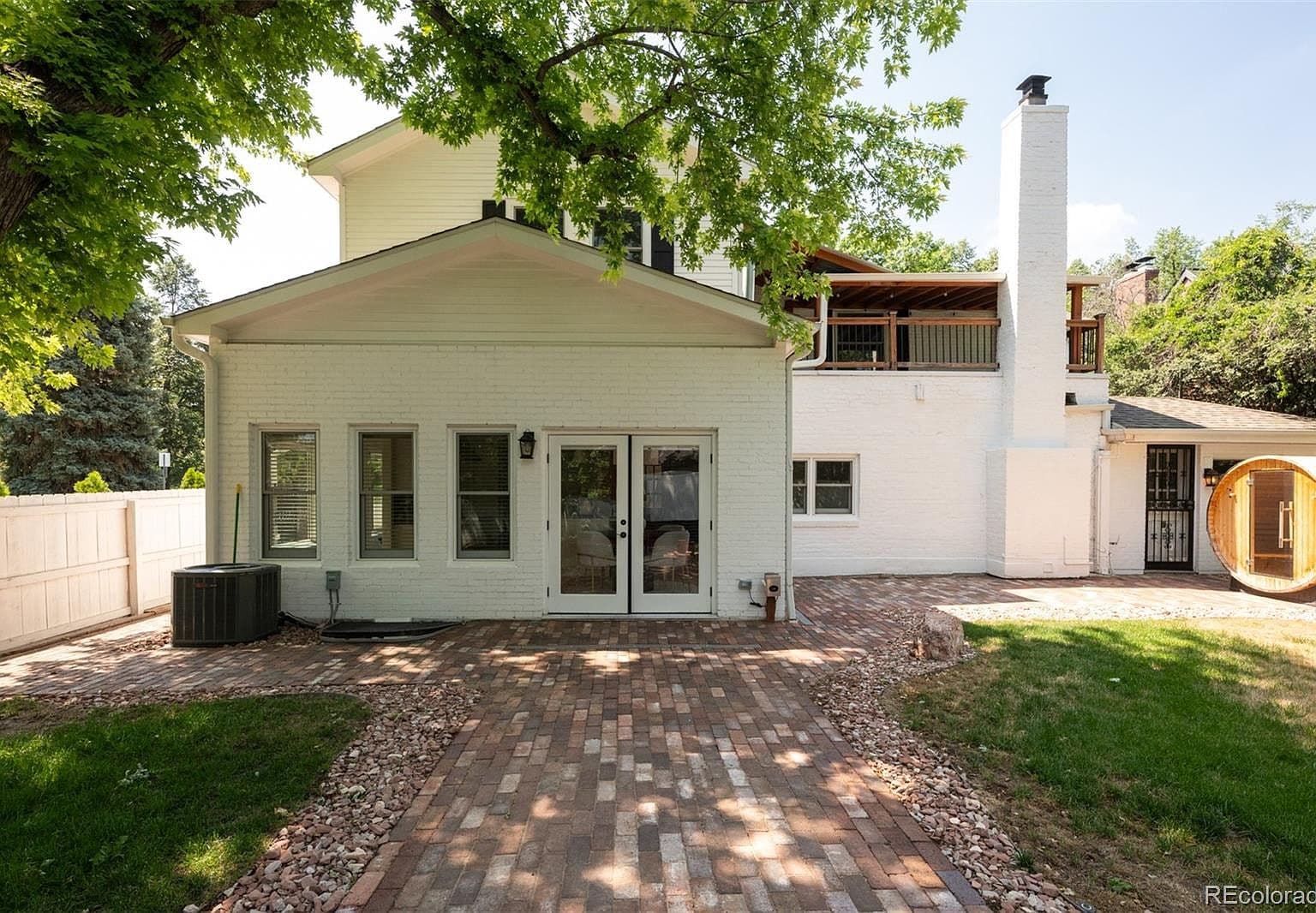 Rear exterior with brick patio and French doors