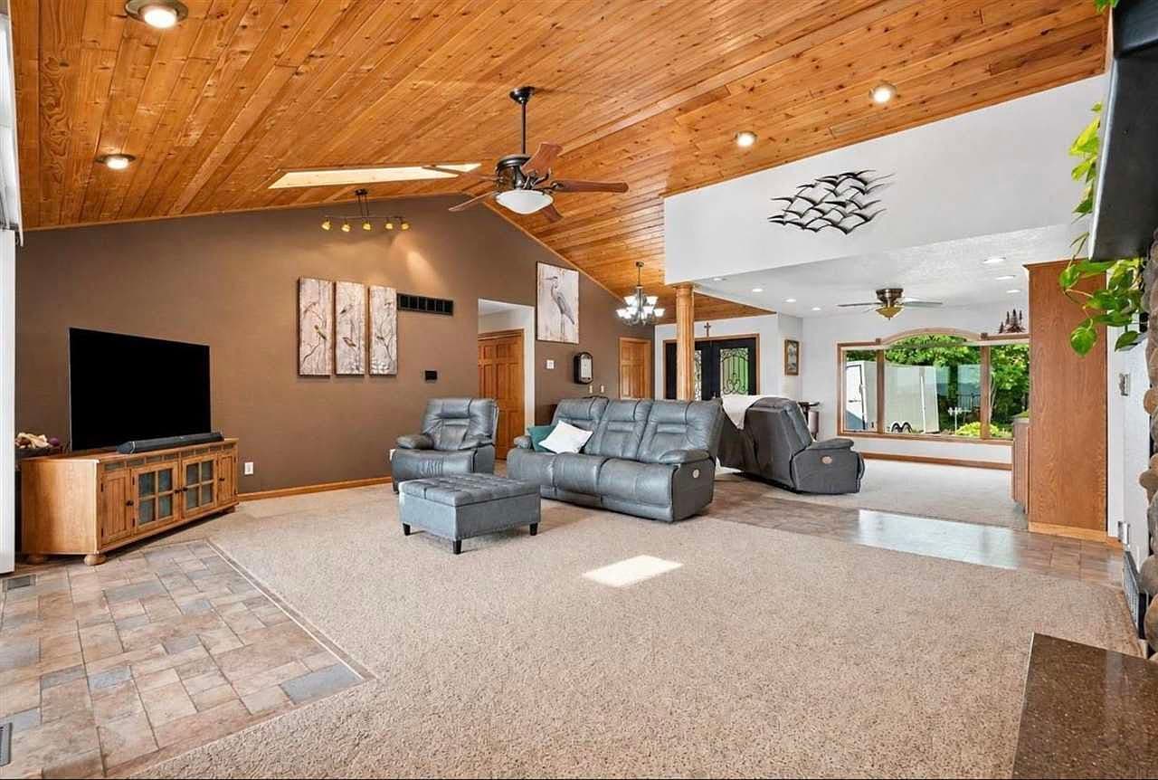 Spacious open living area under dramatic wood ceilings.