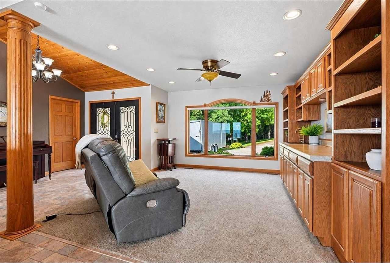 Built-in cabinetry and bright picture window for relaxing.