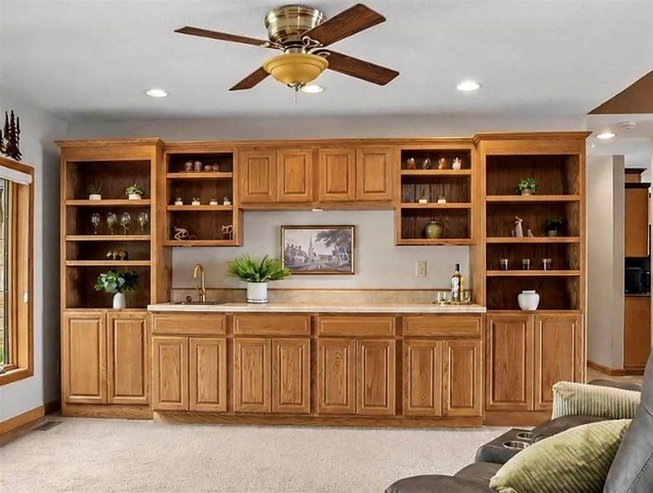 Elegant wet bar with abundant storage and open shelving.