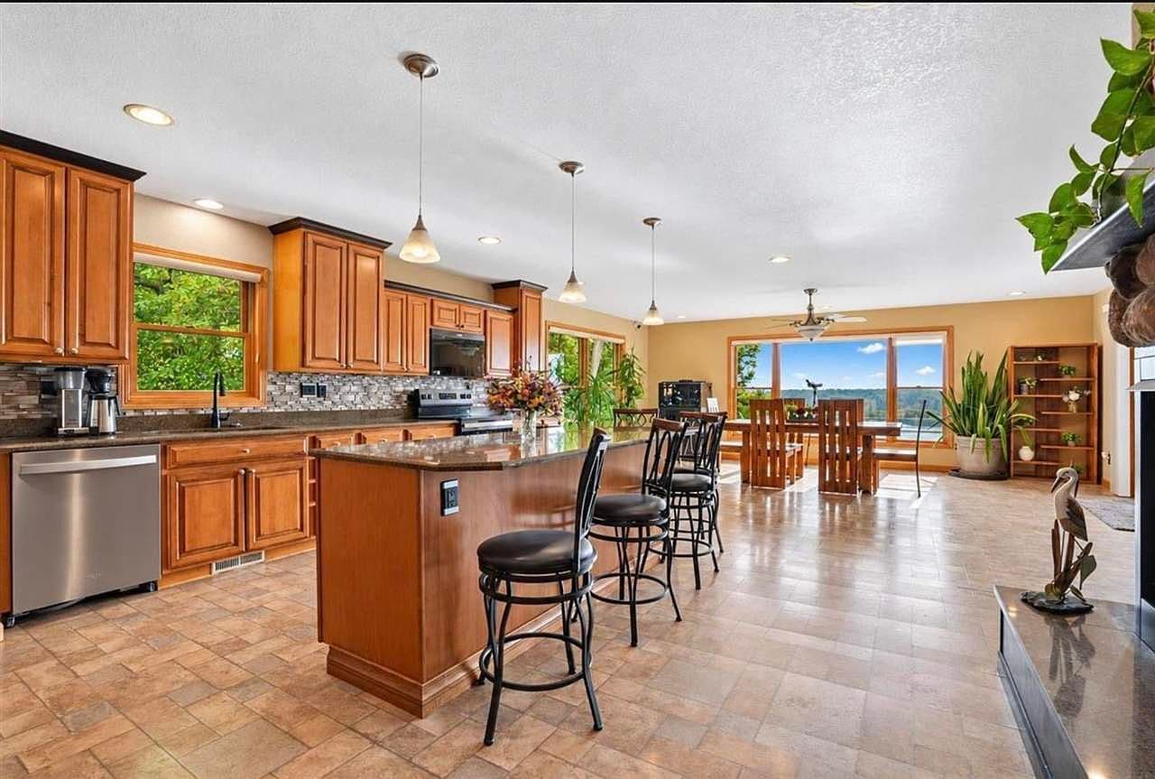 Open-concept kitchen and dining showcasing Mississippi River vistas.