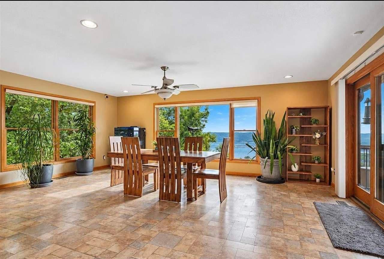 Dining area framed by sweeping river and city views.