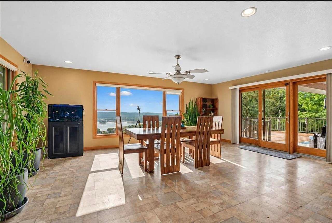 Sunlit dining area with panoramic Mississippi River views.