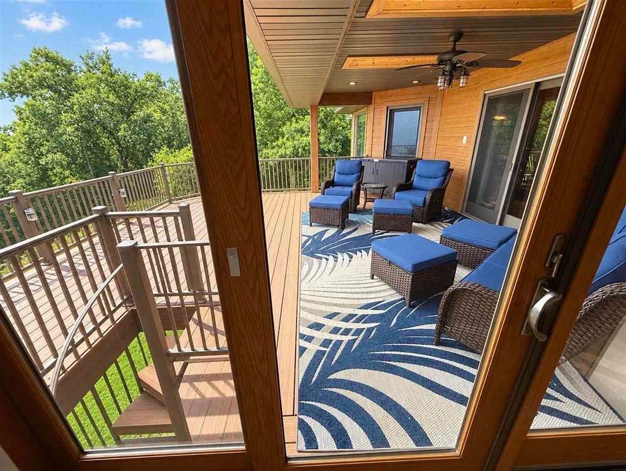 Covered composite deck lounge, steps to soothing hot tub.