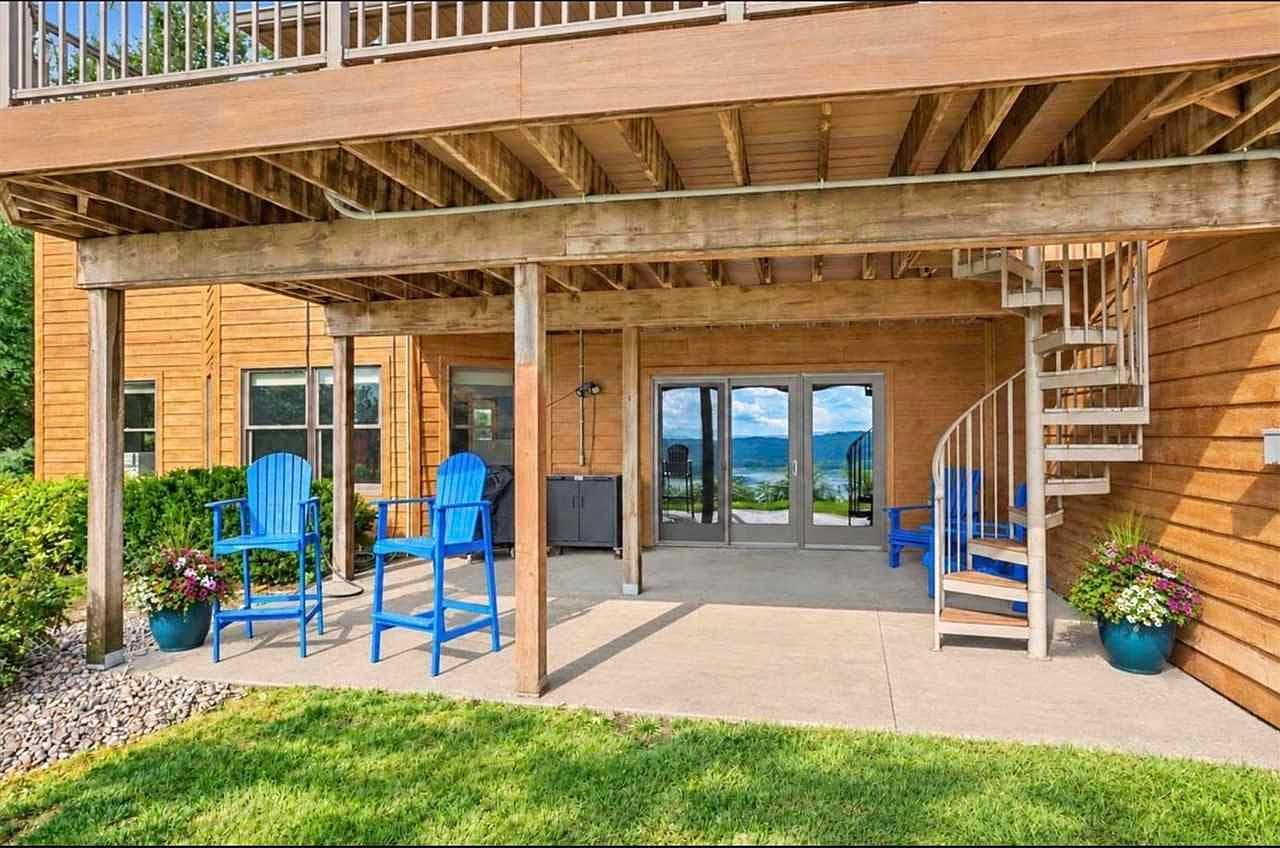 Walkout patio retreat with river views and shaded seating.