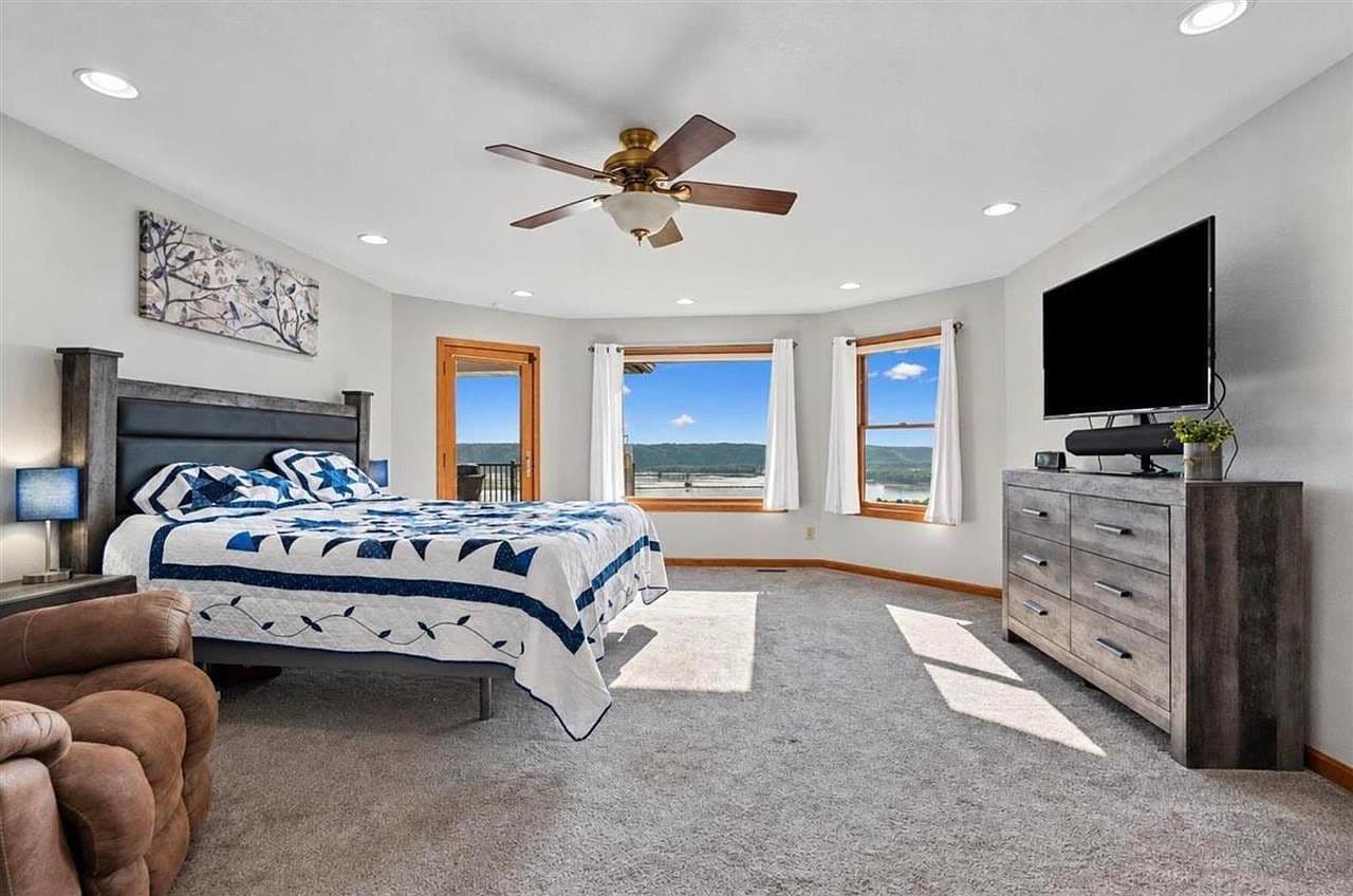 Spacious main-floor bedroom with stunning river-view windows.